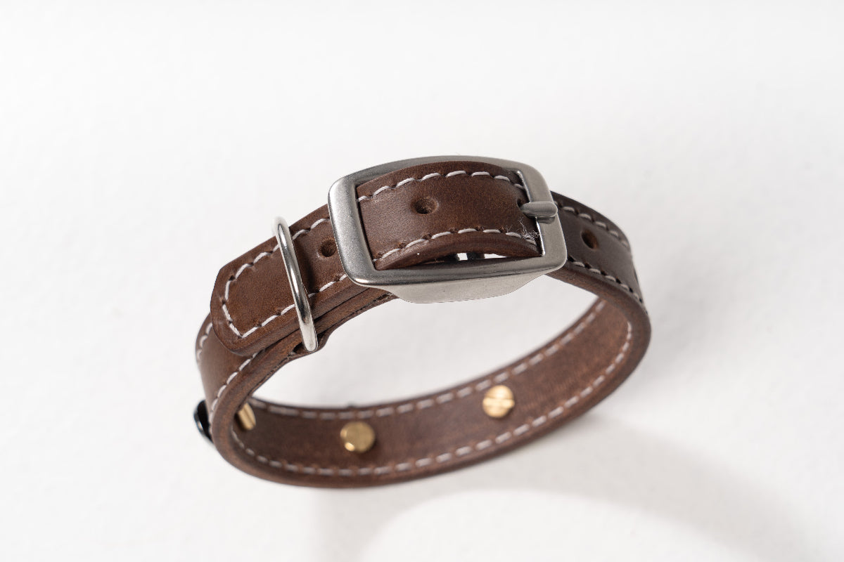 Handcrafted luxury leather collar for dogs by Mou Mou Couture with stainless steel accessories displayed on a white background