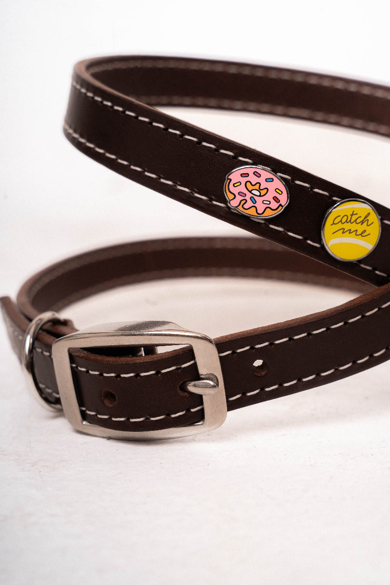 Handcrafted luxury leather harness for dogs by Mou Mou Couture with stainless steel accessories and removable charms displayed on a white background