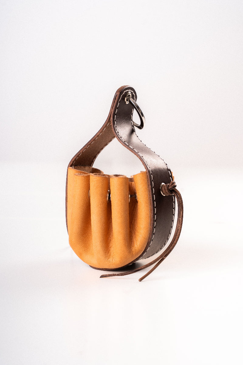 Handmade leather dog pouch for sanitary bags or treats from Mou Mou Couture displayed on a white background