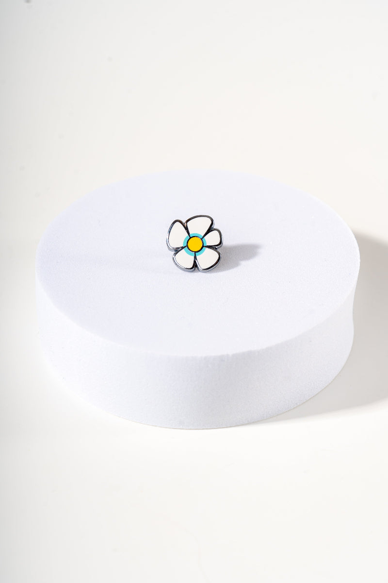 Removable metal flower shaped charm for dog's collar original design by Mou Mou Couture displayed on white background.