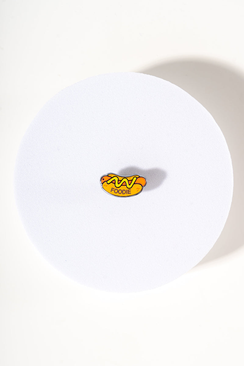 Removable metal hot dog shaped charm for dog's collar original design by Mou Mou Couture displayed on white background.