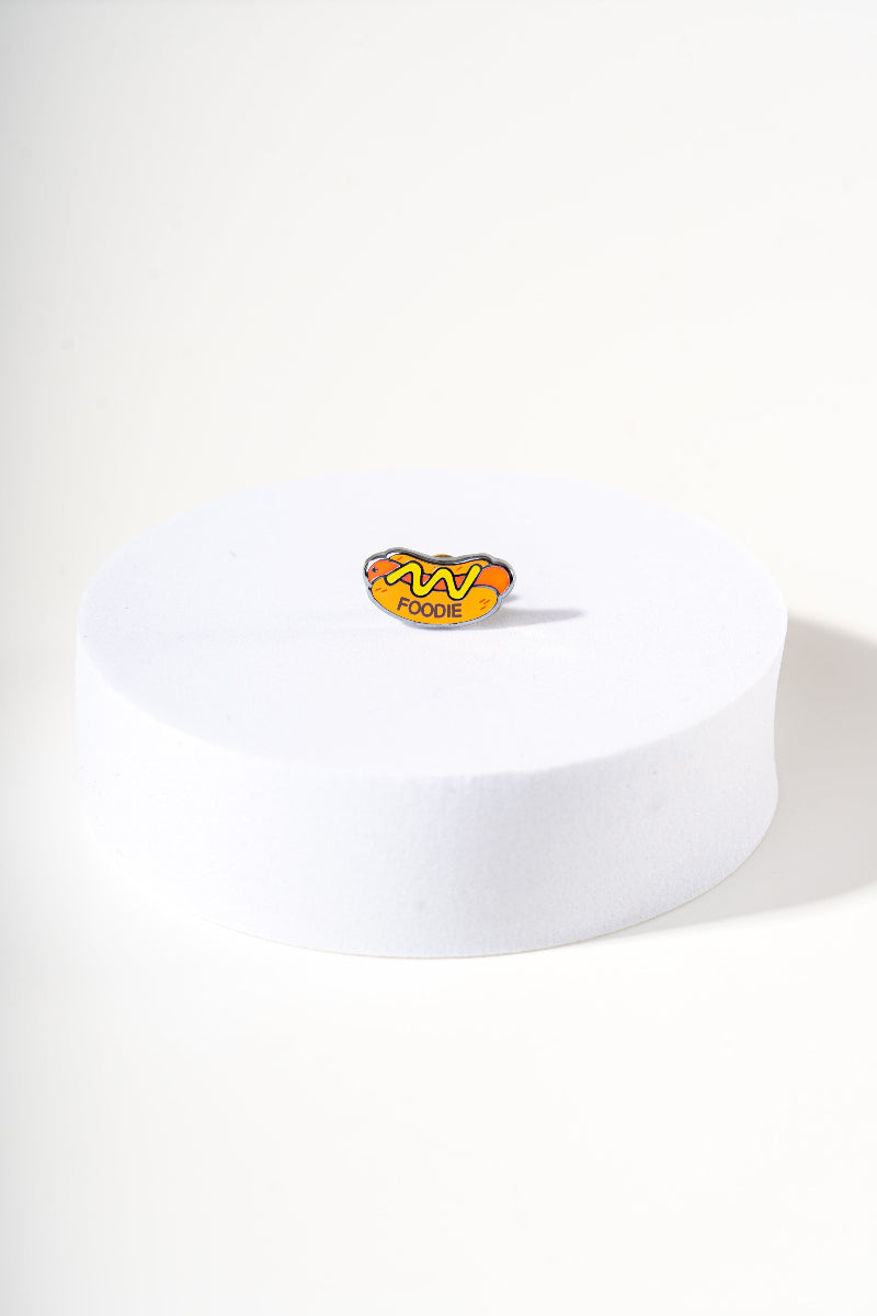 Removable metal hot dog shaped charm for dog's collar original design by Mou Mou Couture displayed on white background.
