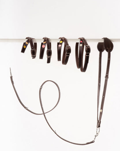 Handmade leather dog harnesses and leashes  from Mou Mou Couture displayed on a white background