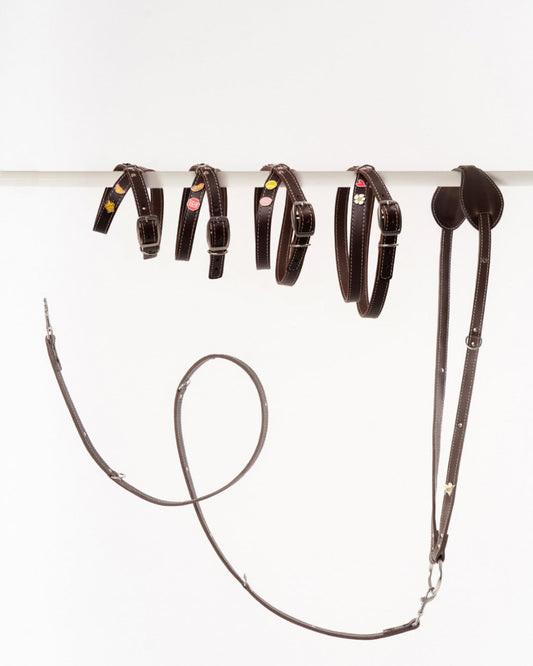 Handmade leather dog harnesses and leashes  from Mou Mou Couture displayed on a white background