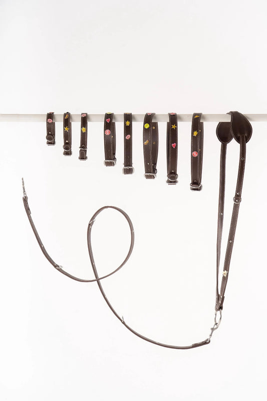 Handmade leather dog collars and leashes  from Mou Mou Couture displayed on a white background