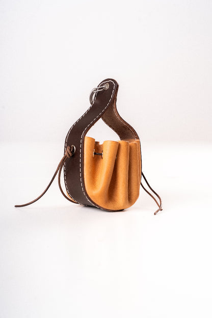 Handmade leather dog pouch for sanitary bags or treats from Mou Mou Couture displayed on a white background