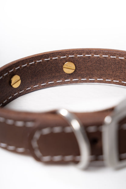 Handcrafted luxury leather collar by Mou Mou Couture with detail on closure of removable charms displayed on white background