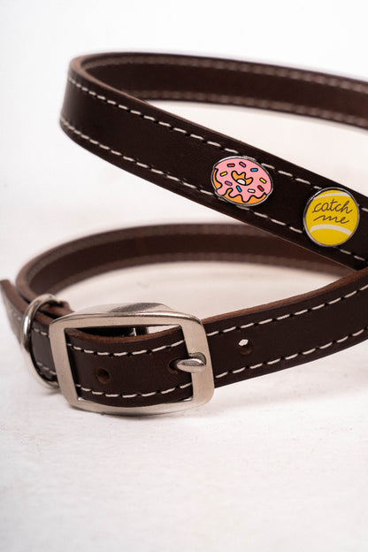 Handcrafted luxury leather harness for dogs by Mou Mou Couture with stainless steel accessories and removable charms displayed on a white background