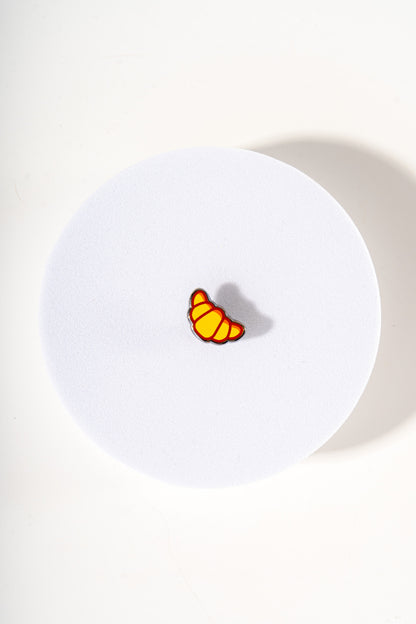 Removable metal croissant shaped charm for dog's collar original design by Mou Mou Couture displayed on white background.