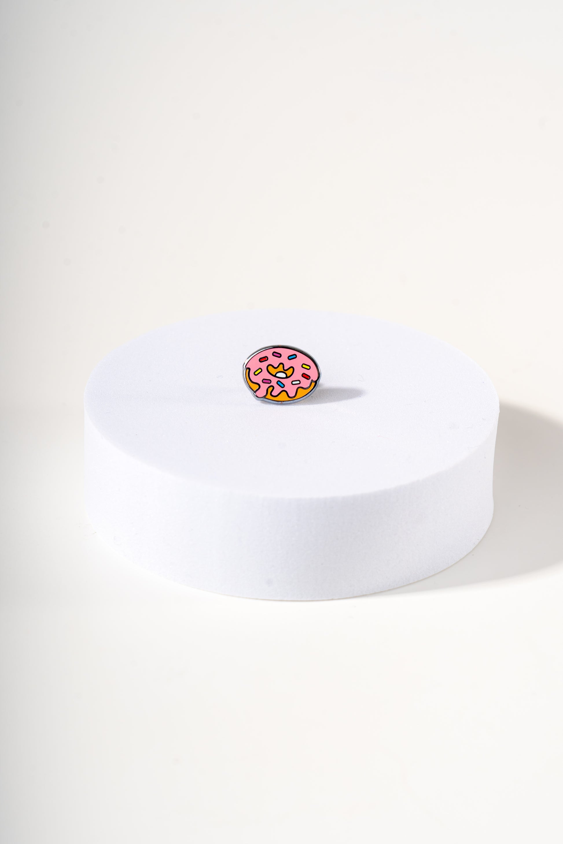 Removable metal donut shaped charm for dog's collar original design by Mou Mou Couture displayed on white background.
