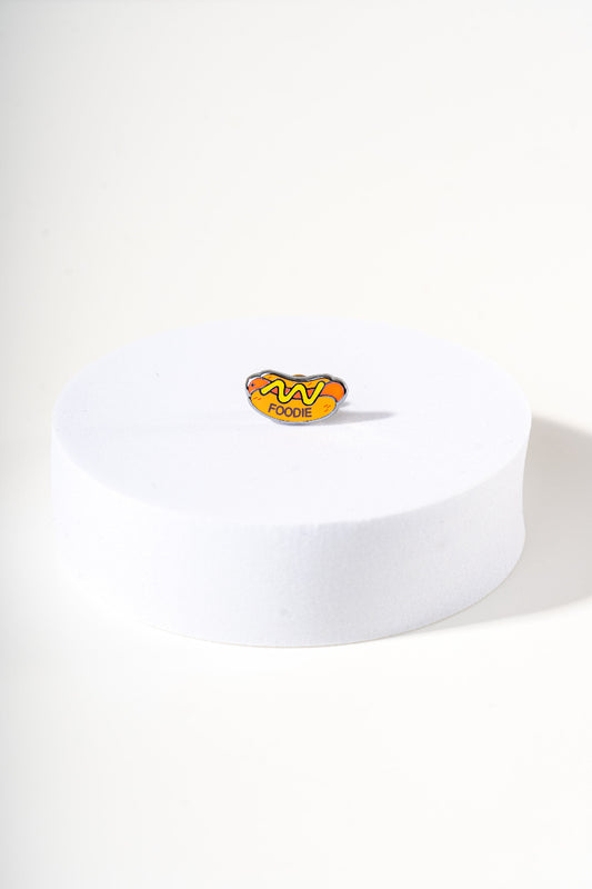 Removable metal hot dog shaped charm for dog's collar original design by Mou Mou Couture displayed on white background.